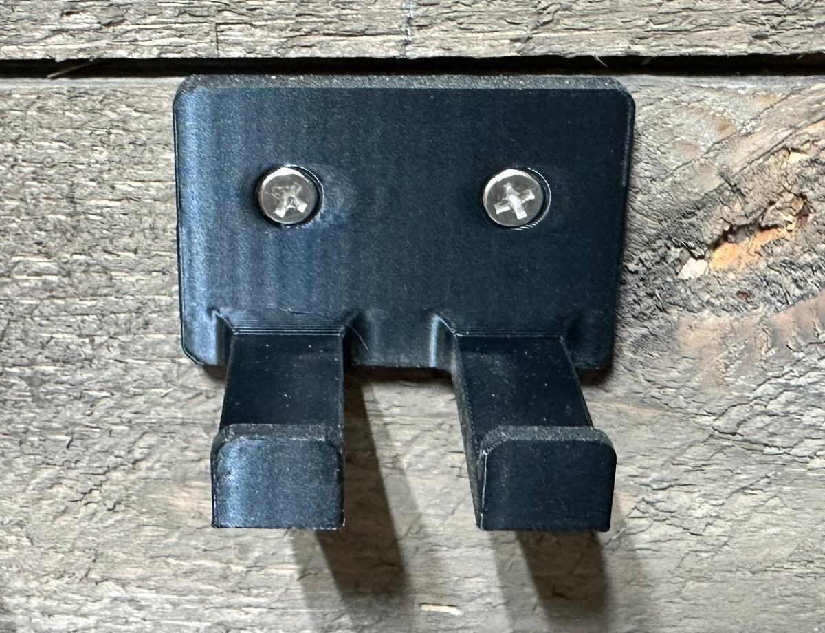 Close-up of the black two-prong corner clamp wall mount