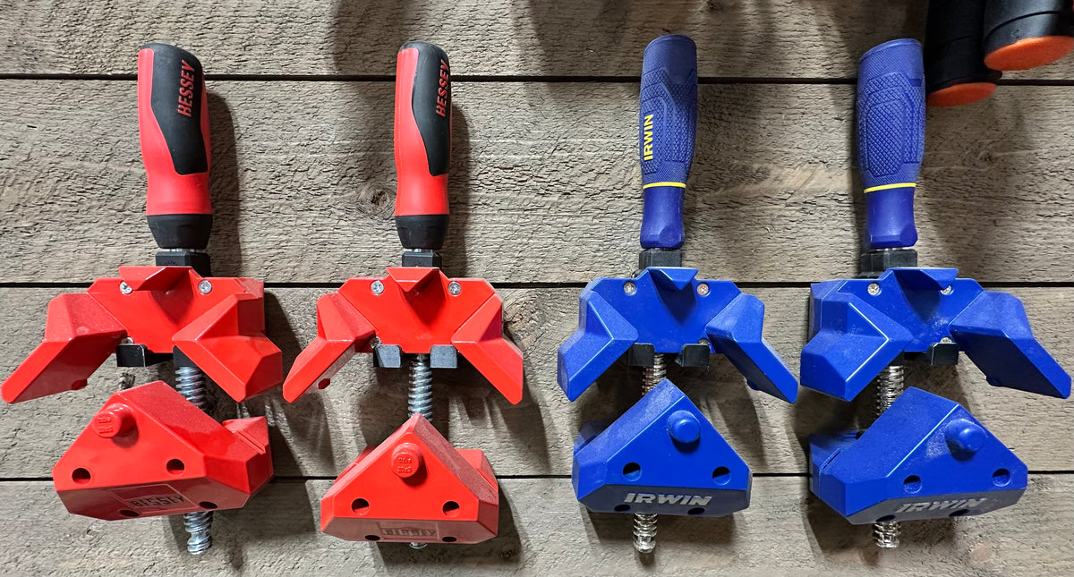 Bessey and Irwin corner clamps hanging on black wall mounts